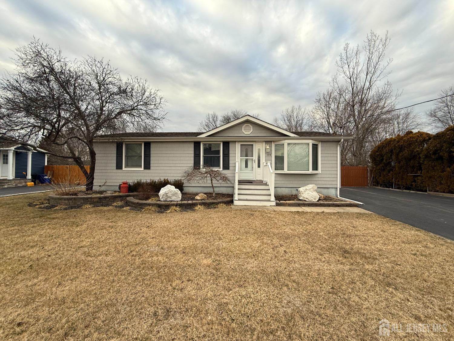109 John Street Helmetta, NJ 08828 - Photo 1 of 18 a front view of a house with a yard