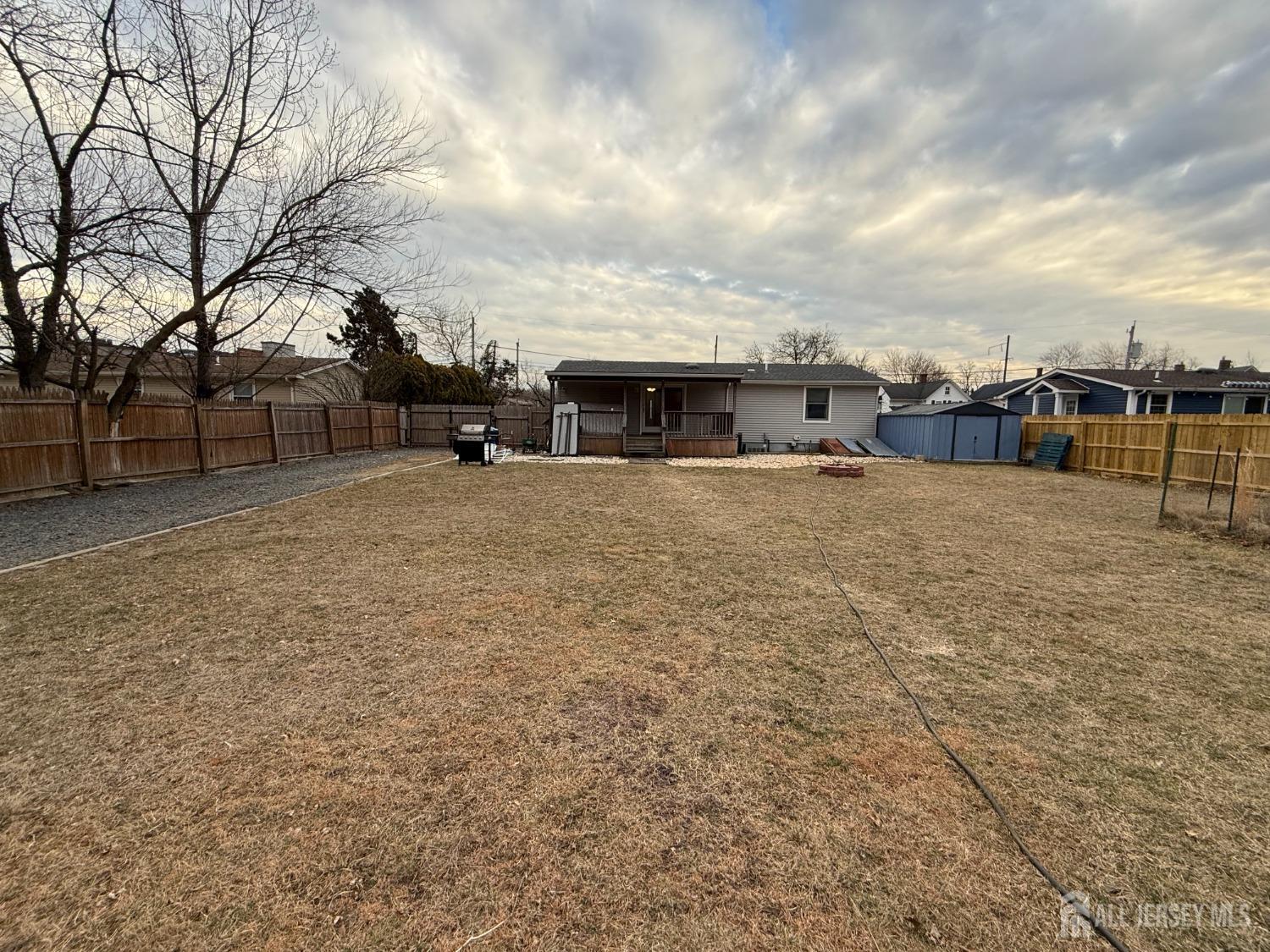 109 John Street Helmetta, NJ 08828 - Photo 17 of 18 a backyard of a house with table and chairs