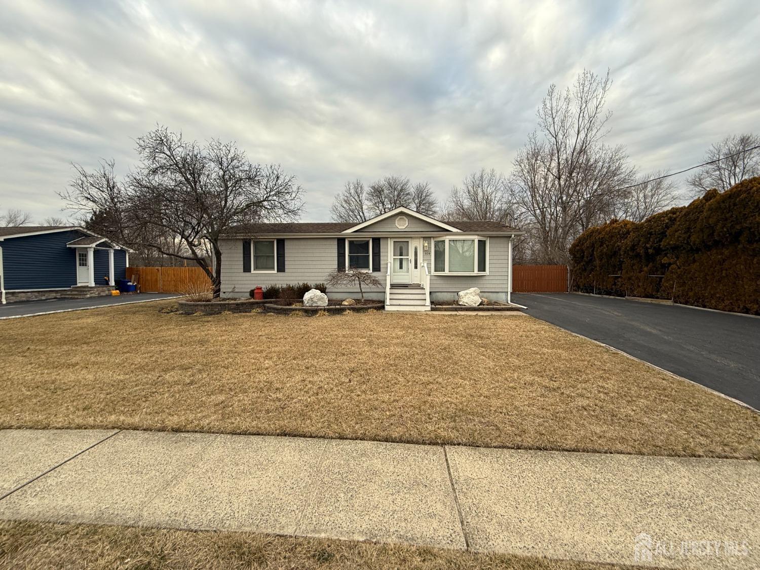 109 John Street Helmetta, NJ 08828 - Photo 18 of 18 a front view of a house with a yard and garage