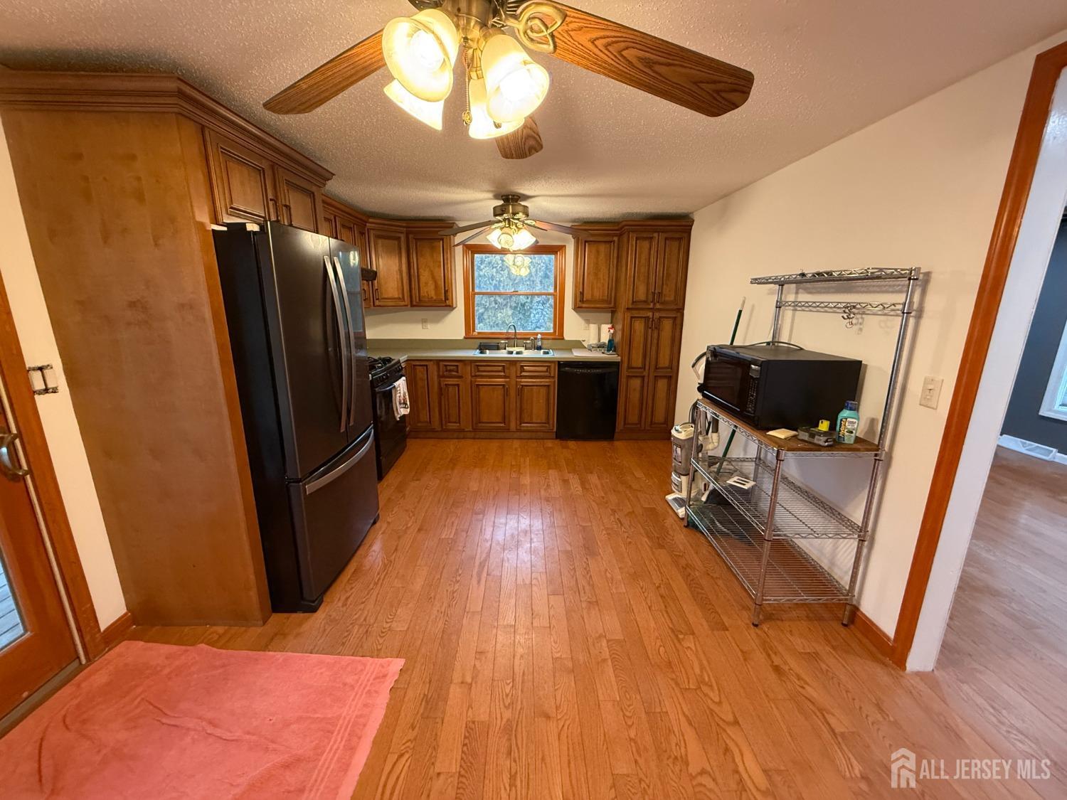 109 John Street Helmetta, NJ 08828 - Photo 4 of 18 a open kitchen with stainless steel appliances granite countertop a refrigerator a stove and a wooden floors