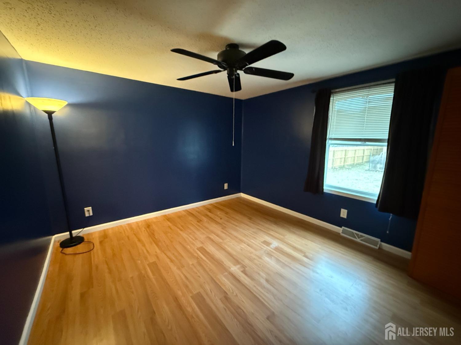 109 John Street Helmetta, NJ 08828 - Photo 10 of 18 a view of a room with a ceiling fan and wooden floor