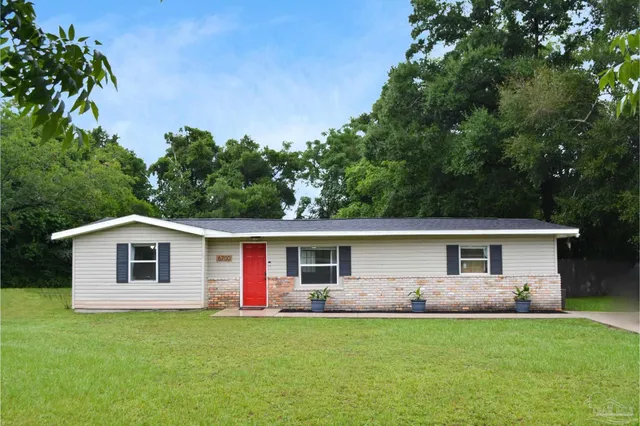 a front view of a house with a garden