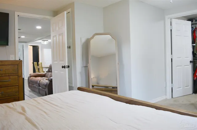 a view of a backyard with wooden fence and large trees