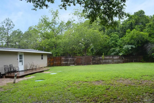 a view of a house with a yard and garage