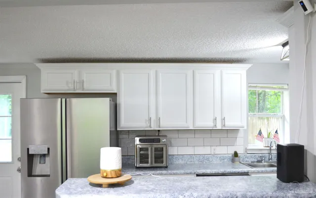 a kitchen with a refrigerator and window