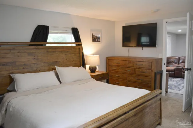 a bedroom with a bed and a mirror