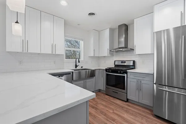 a kitchen with stainless steel appliances a sink stove and refrigerator