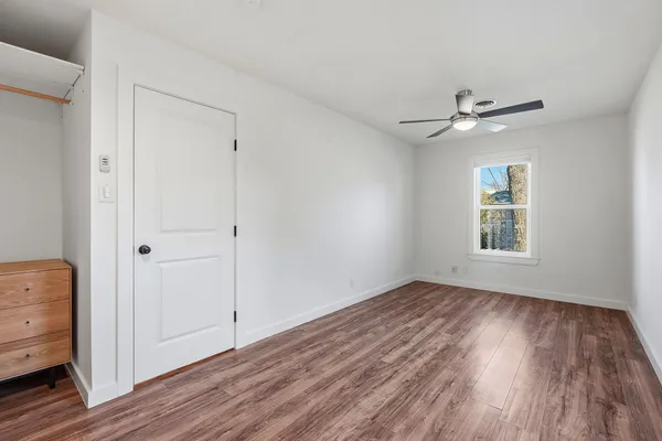 a view of room with hardwood floor and ceiling fan