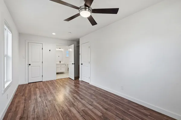 a view of an empty room and wooden floor