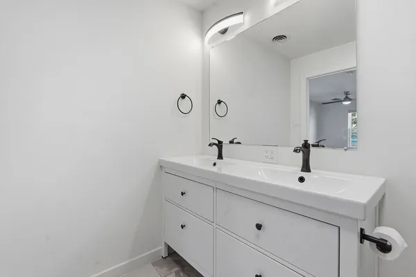 a bathroom with a sink and mirror