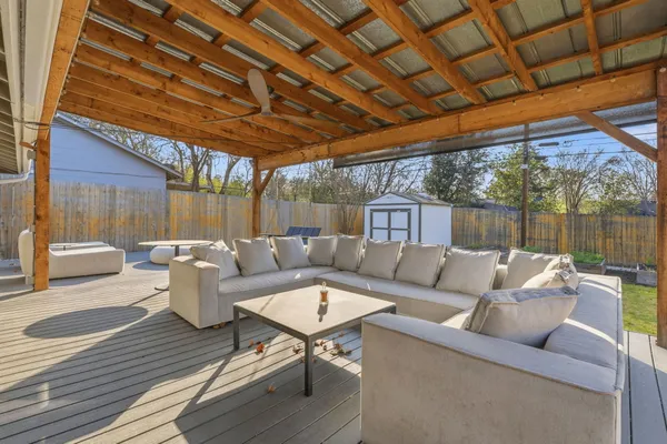 a view of a patio with a table and chairs next to a yard