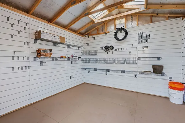 a view of a big yard with table and chairs under an umbrella