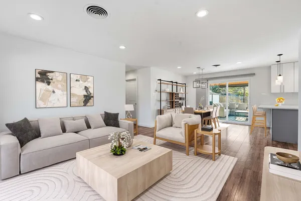 a living room with furniture and wooden floor