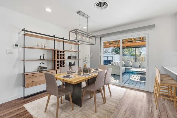 a view of a dining room with furniture window and wooden floor