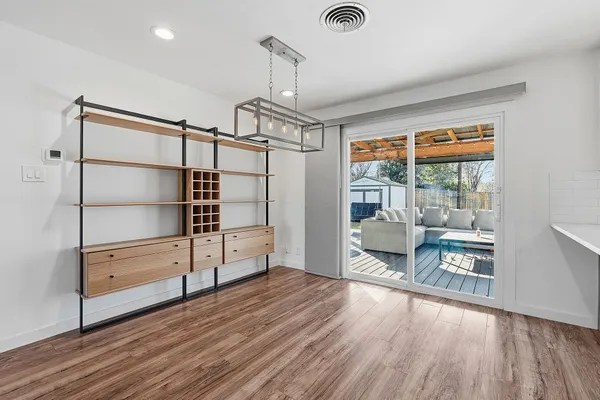 a empty room with wooden floor and large window