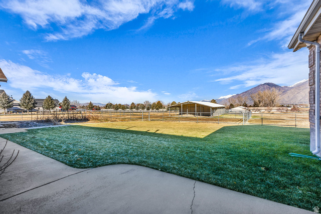 1060 West 2620th Street South Mapleton, UT 84664 - Photo 79 of 87 View of yard with a patio area, a view of countryside, a mountain view, and an outbuilding