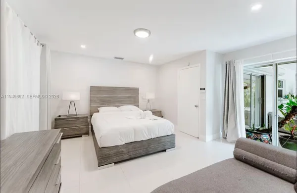 a bedroom with a bed and glass window