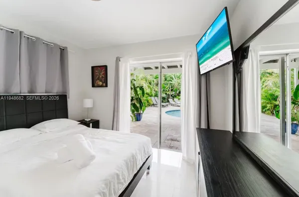 a bedroom with a bed and a large window