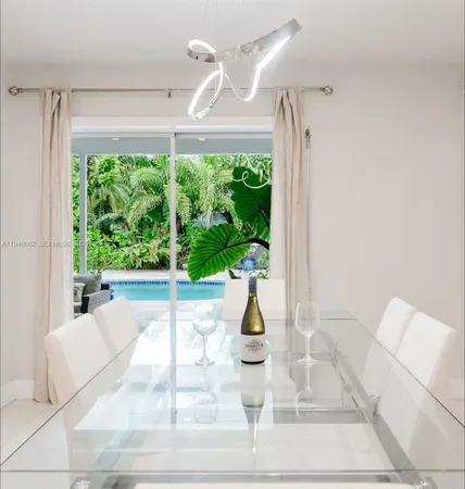 a view of a living room and floor to ceiling window with yard