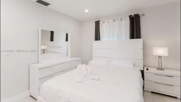 a bed room with a bed and a night stand