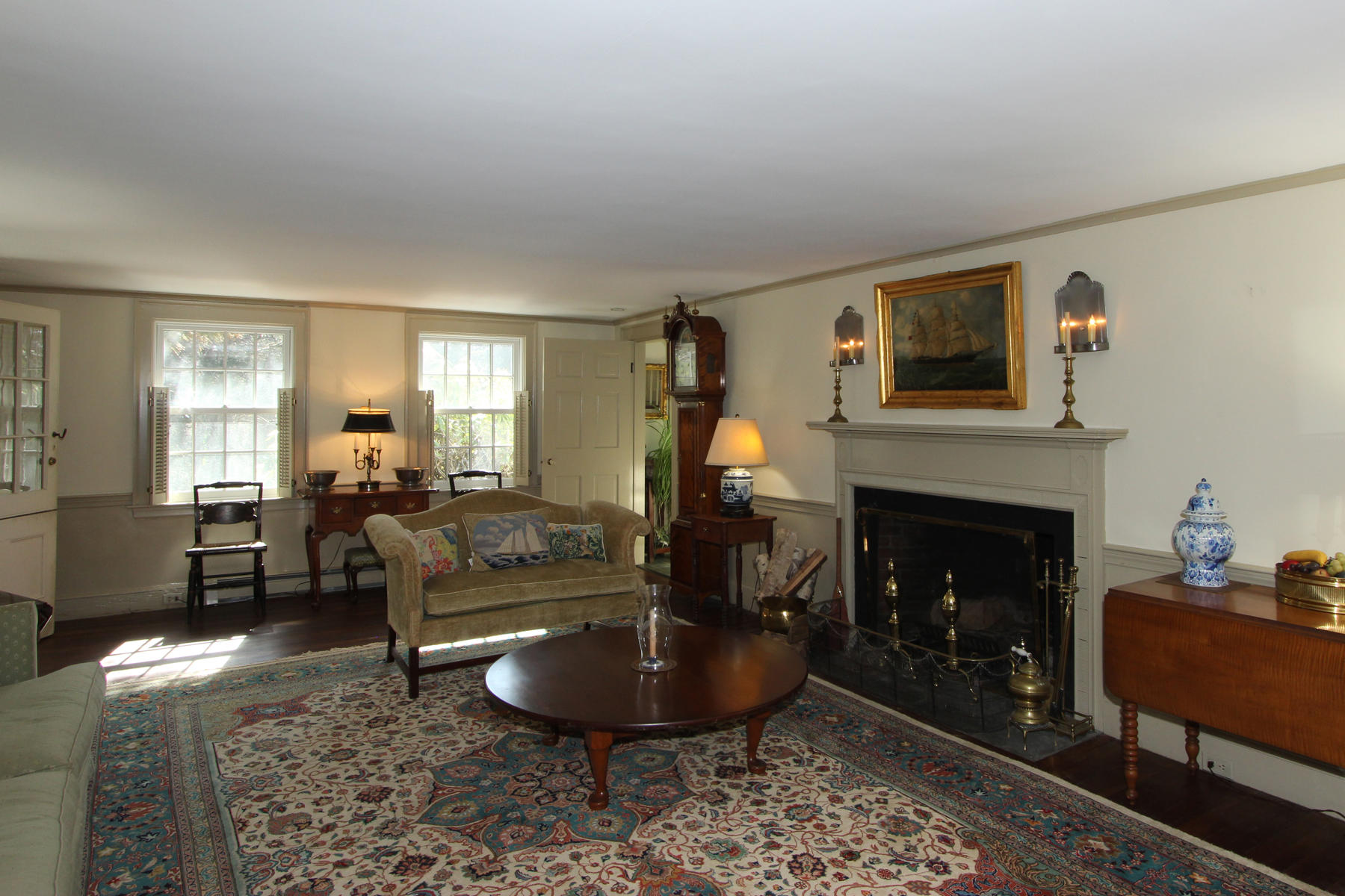 163 Pochet Road Orleans, MA 02653 - Photo 12 of 67 a living room with furniture a fireplace and a large mirror