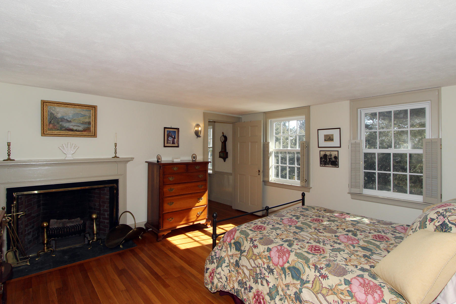 163 Pochet Road Orleans, MA 02653 - Photo 32 of 67 a bedroom with furniture and a fireplace