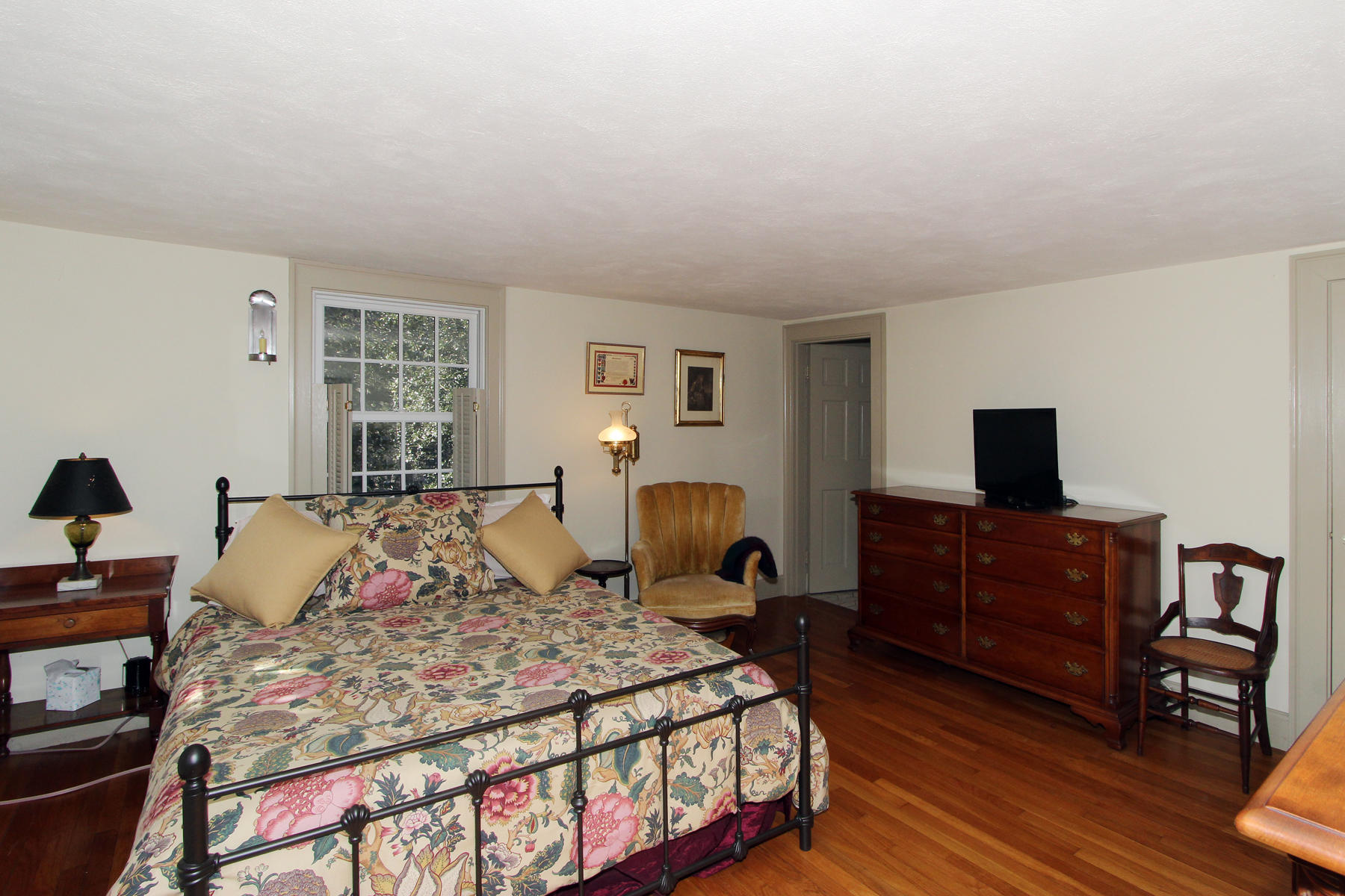 163 Pochet Road Orleans, MA 02653 - Photo 33 of 67 a bedroom with a bed and wooden floor
