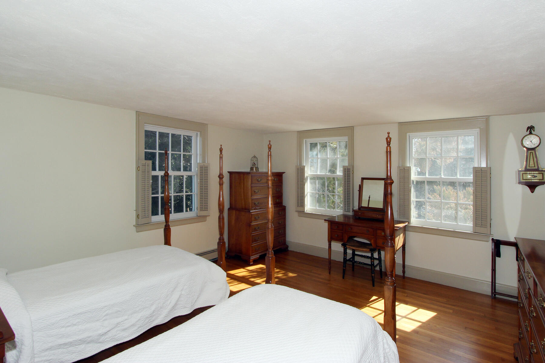 163 Pochet Road Orleans, MA 02653 - Photo 37 of 67 a bedroom with a bed a table and a window