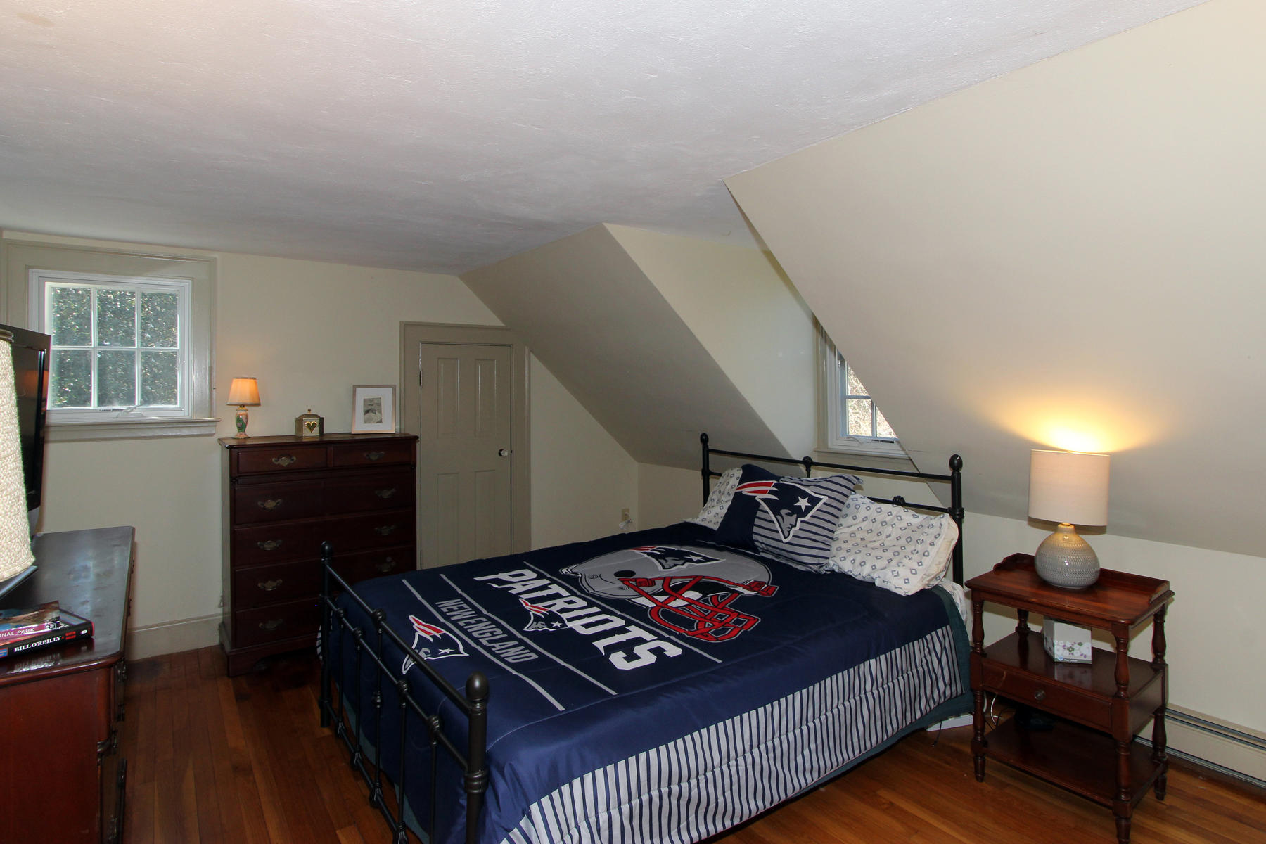163 Pochet Road Orleans, MA 02653 - Photo 38 of 67 a bedroom with a bed and wooden floor