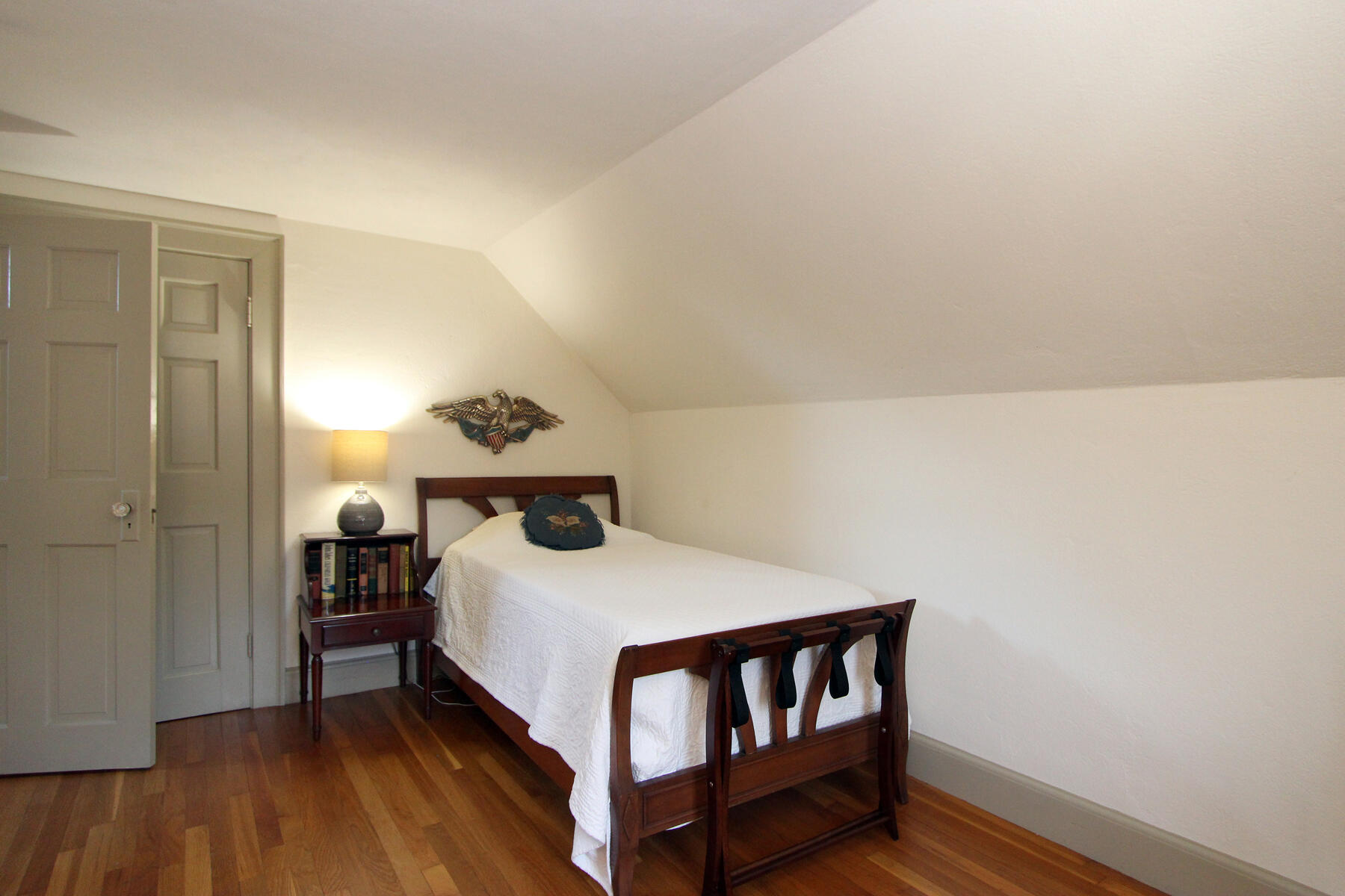 163 Pochet Road Orleans, MA 02653 - Photo 48 of 67 a bedroom with a bed and wooden floor