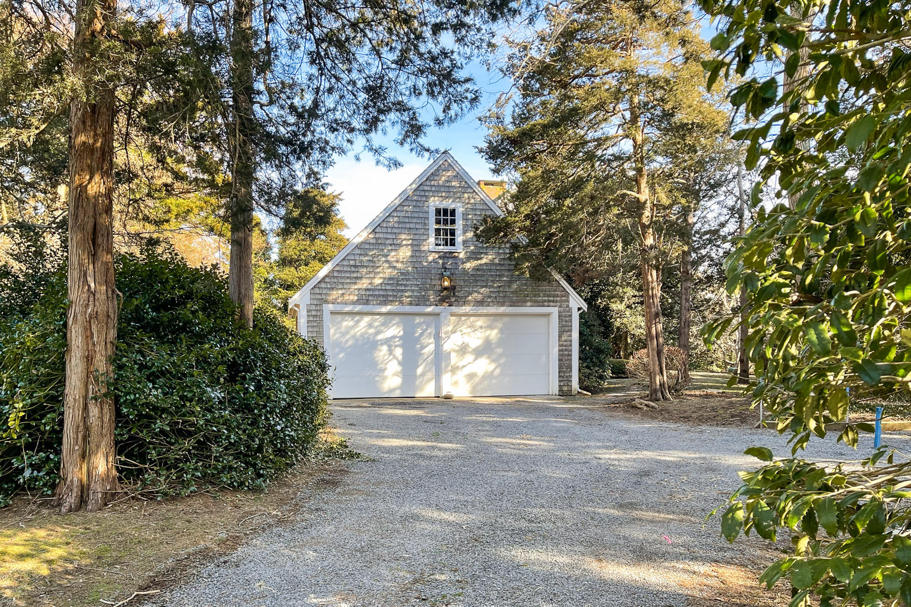 163 Pochet Road Orleans, MA 02653 - Photo 57 of 67 a front view of a house with a garden and trees
