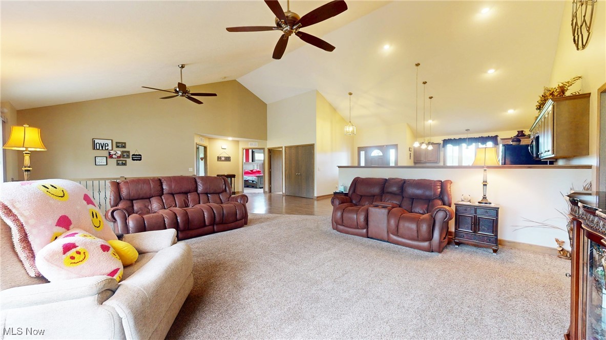 961 Industry Road Atwater, OH 44201 - Photo 9 of 50 Living area featuring high vaulted ceiling, ceiling fan, and carpet floors