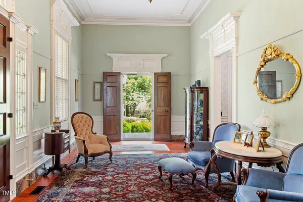 a living room with furniture and a book shelf