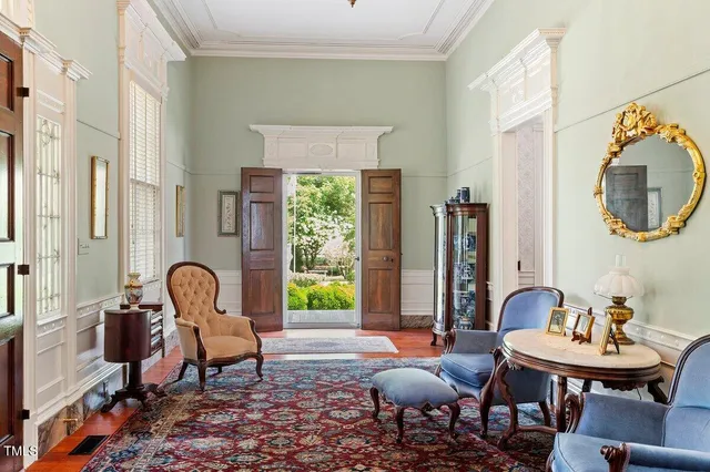 a living room with furniture and a book shelf