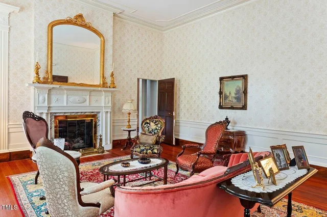 a view of front door and bedroom with wooden floor