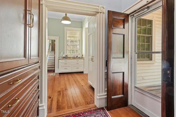 a spacious bedroom with a bed dresser and a window