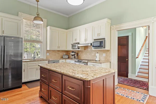 a living room with furniture a large window and a table