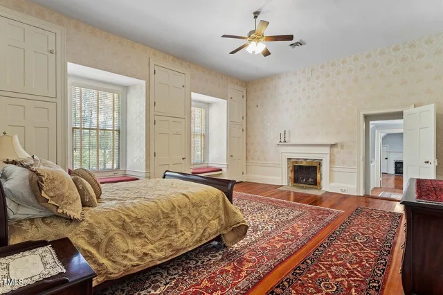 a bedroom with furniture fireplace and a window