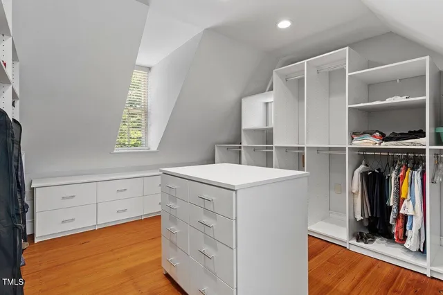 an aerial view of a house with a big yard and large trees