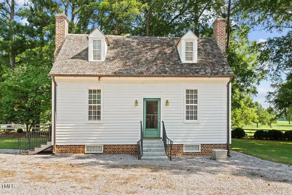 an aerial view of a house with a yard and lake view