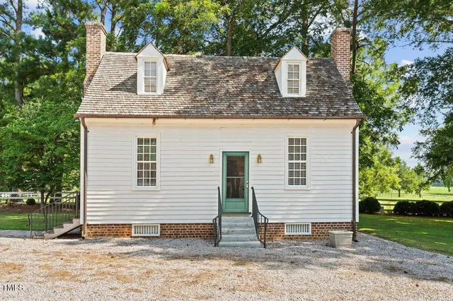an aerial view of a house with a yard and lake view