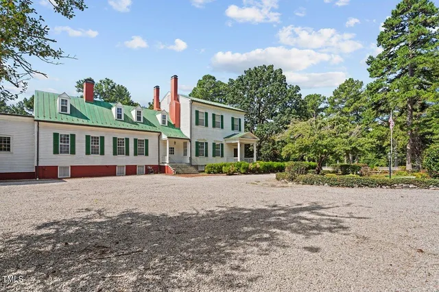 a front view of a house with a yard and a garage