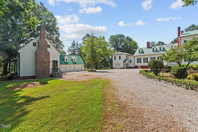 a house view with swimming pool and wooden fence