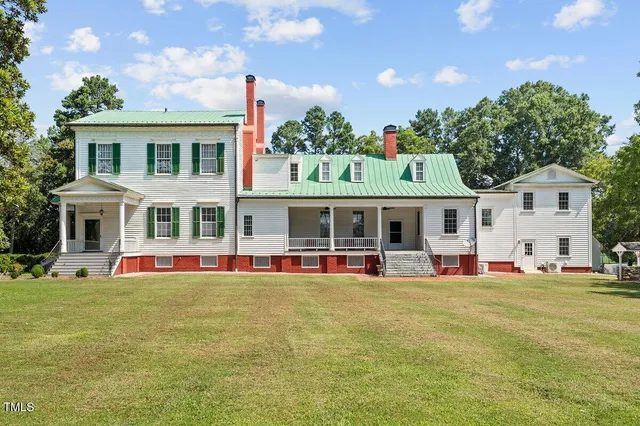 a living room with furniture a fireplace and a table