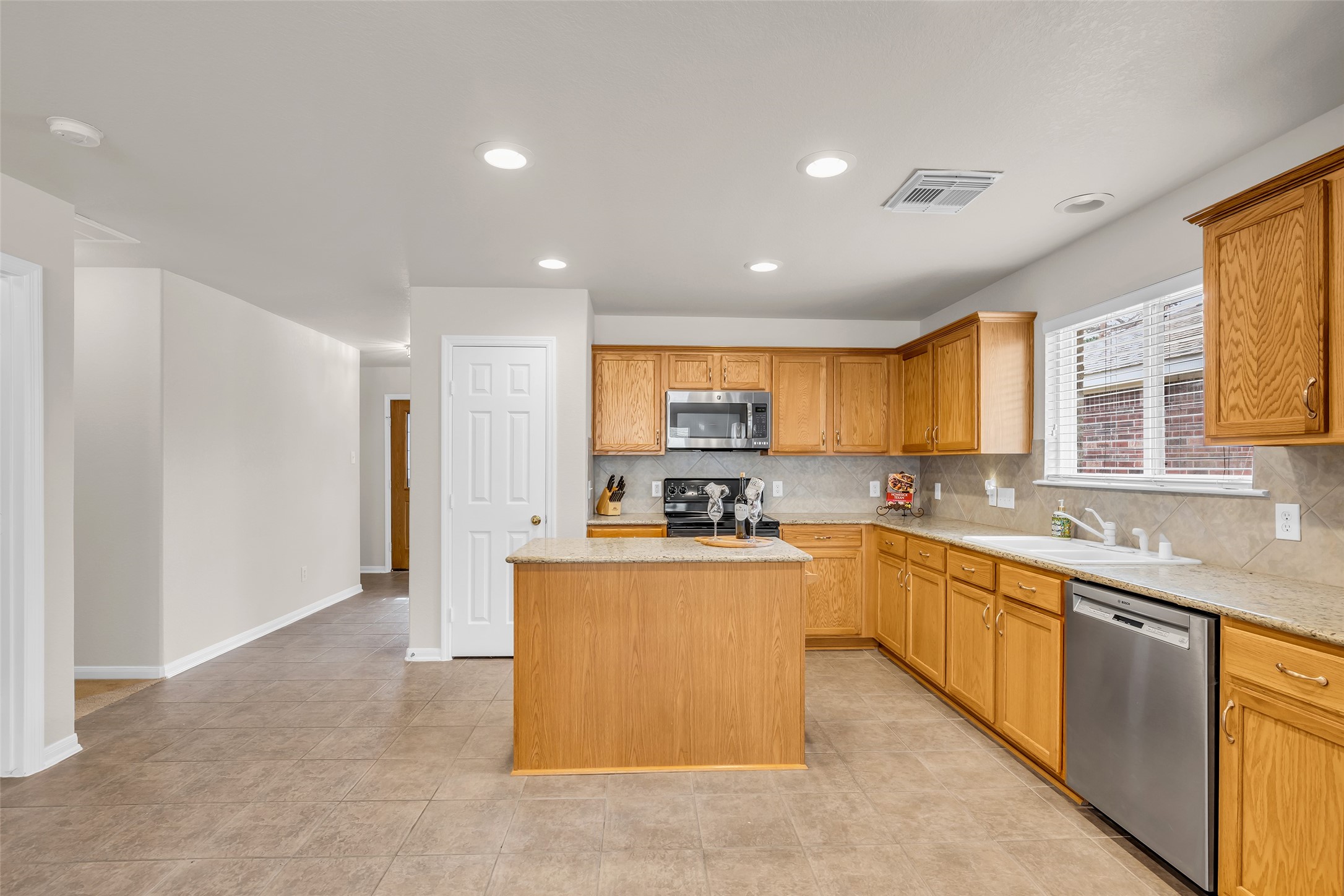 3311 Falcon Trail Drive Spring, TX 77373 - Photo 11 of 36 A general overview photo to show the front door entry and a peek down the hallway to the secondary bedrooms.