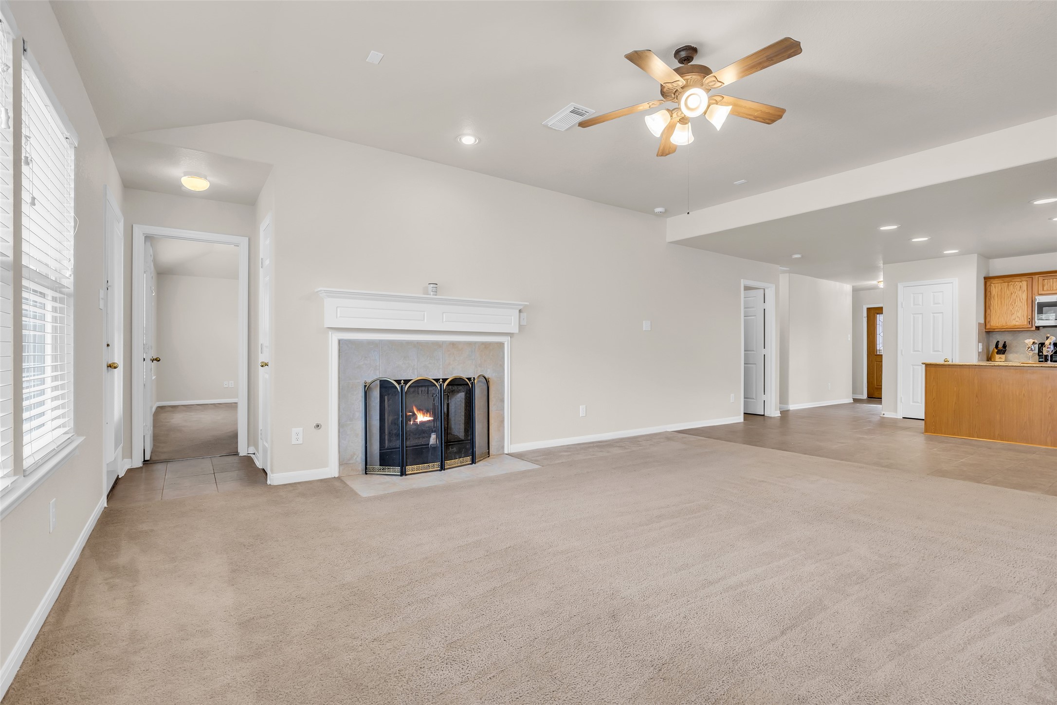 3311 Falcon Trail Drive Spring, TX 77373 - Photo 14 of 36 Enjoy a warm fire from the gaslog fireplace on our colder nights! Open concept living makes it enjoyable for all -- the door shown is to the private primary suite...