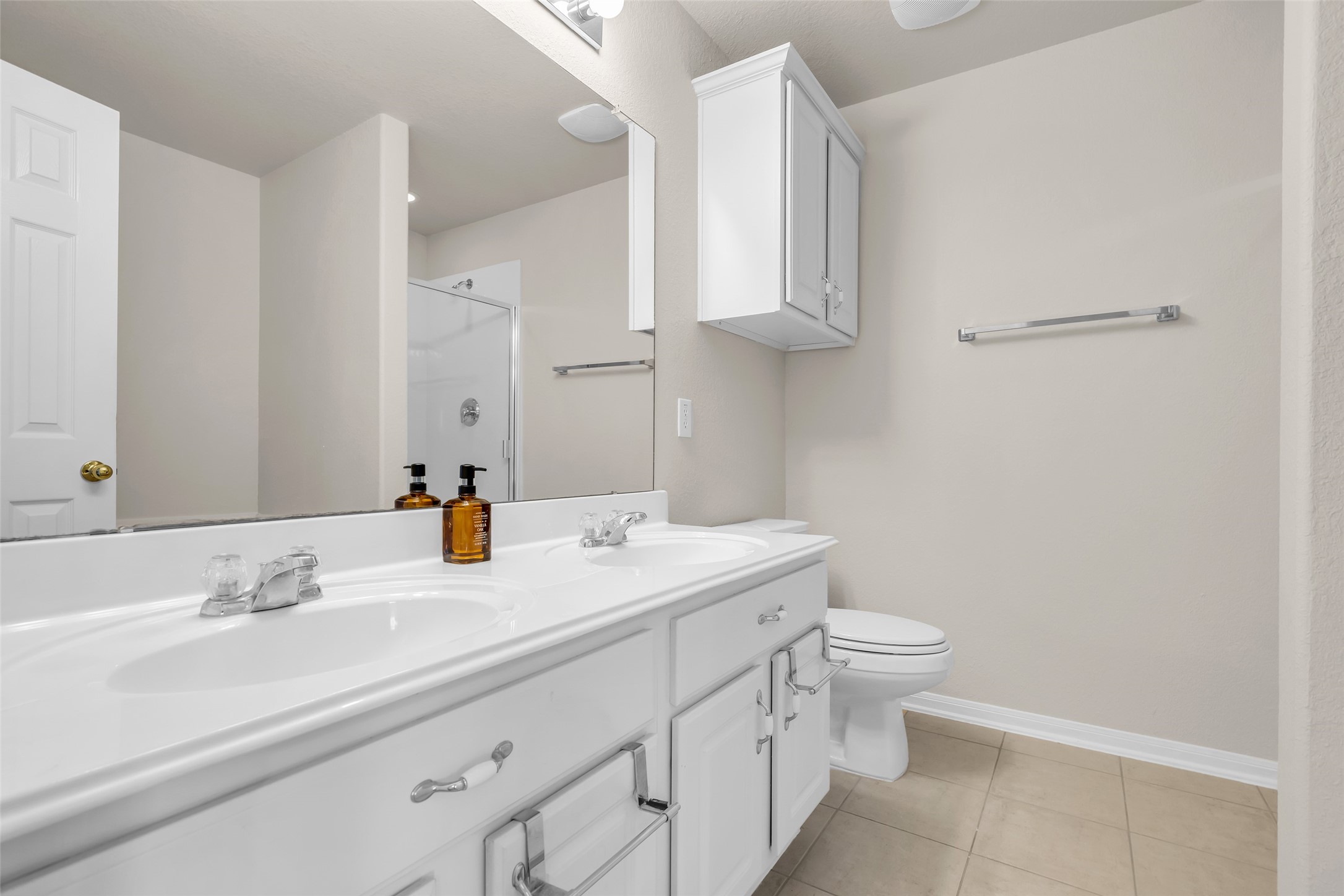 3311 Falcon Trail Drive Spring, TX 77373 - Photo 23 of 36 The primary bath includes double vanity and ample cabinets, including an upper cabinet.