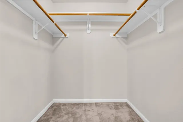 a balcony with furniture and a floor to ceiling window