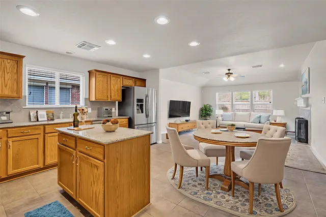 an empty room with windows and fan chandelier