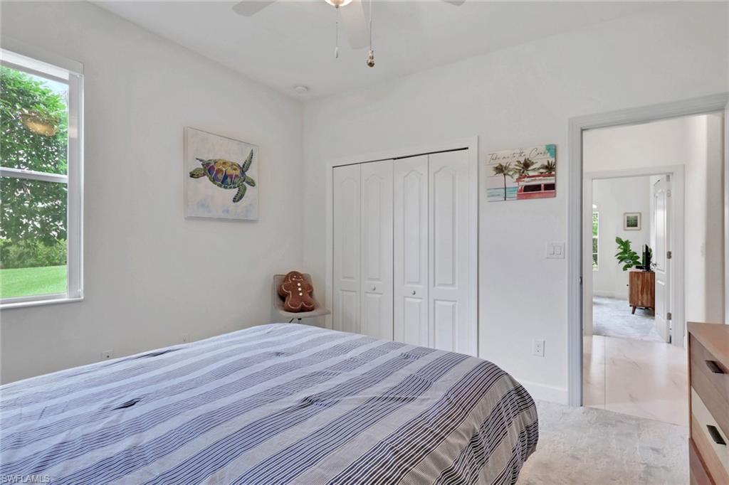 2045 Mandarin Lane Naples, FL 34120 - Photo 24 of 34 a bedroom with a bed and a window